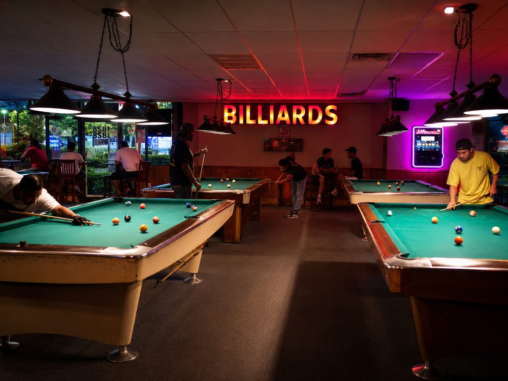 Lounge atmosphere showing active games under warm glowing ceiling lamps